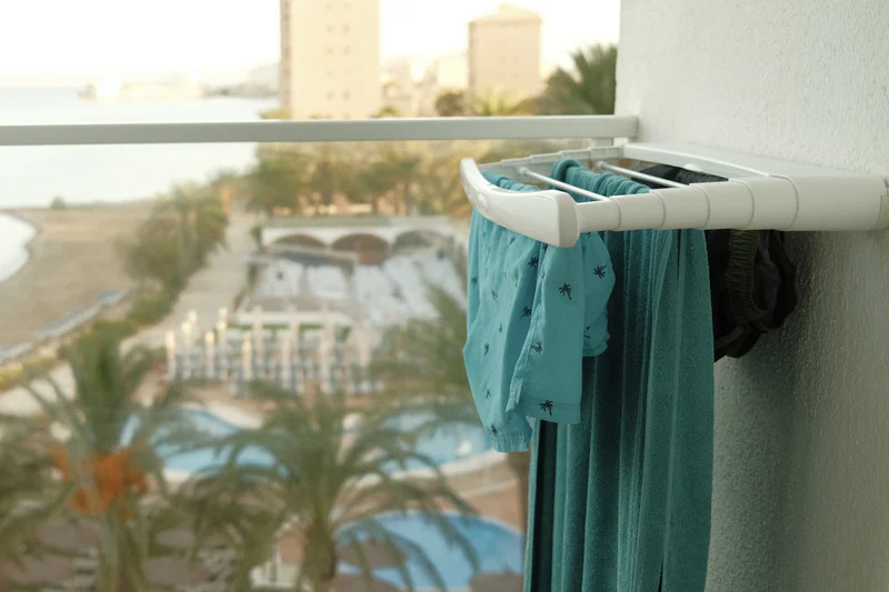 a photograph of a towel hanging on a towel rack in front of a window