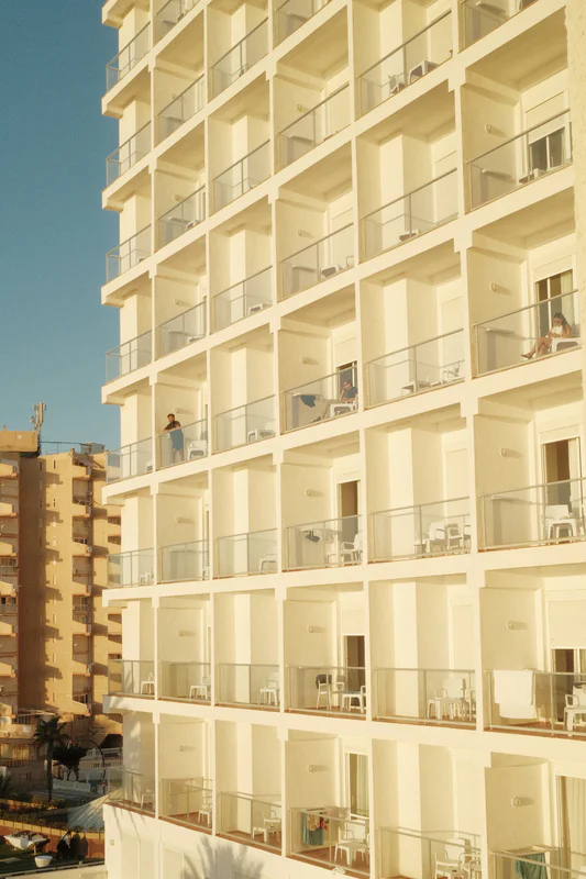 a photograph of a large building with a bunch of balconis and a person on a surf